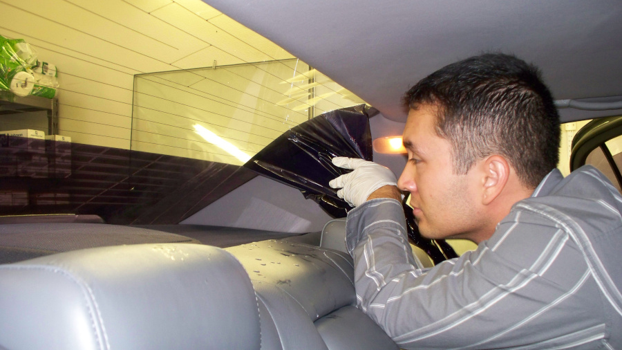 Dan removing film from back glass of a lexus sedan